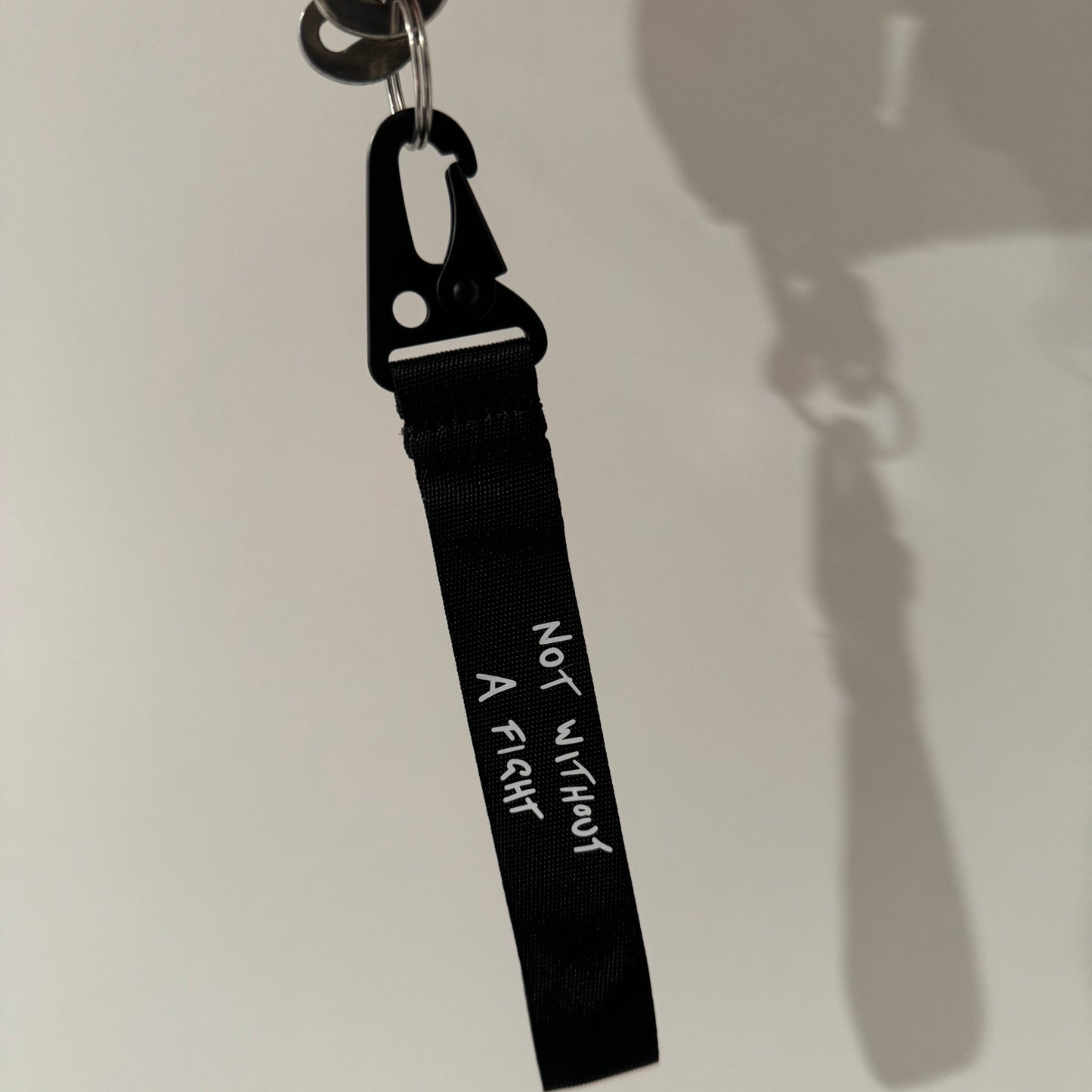 Daniel Ricciardo “Not without a fight” inspired wristlet keychain.